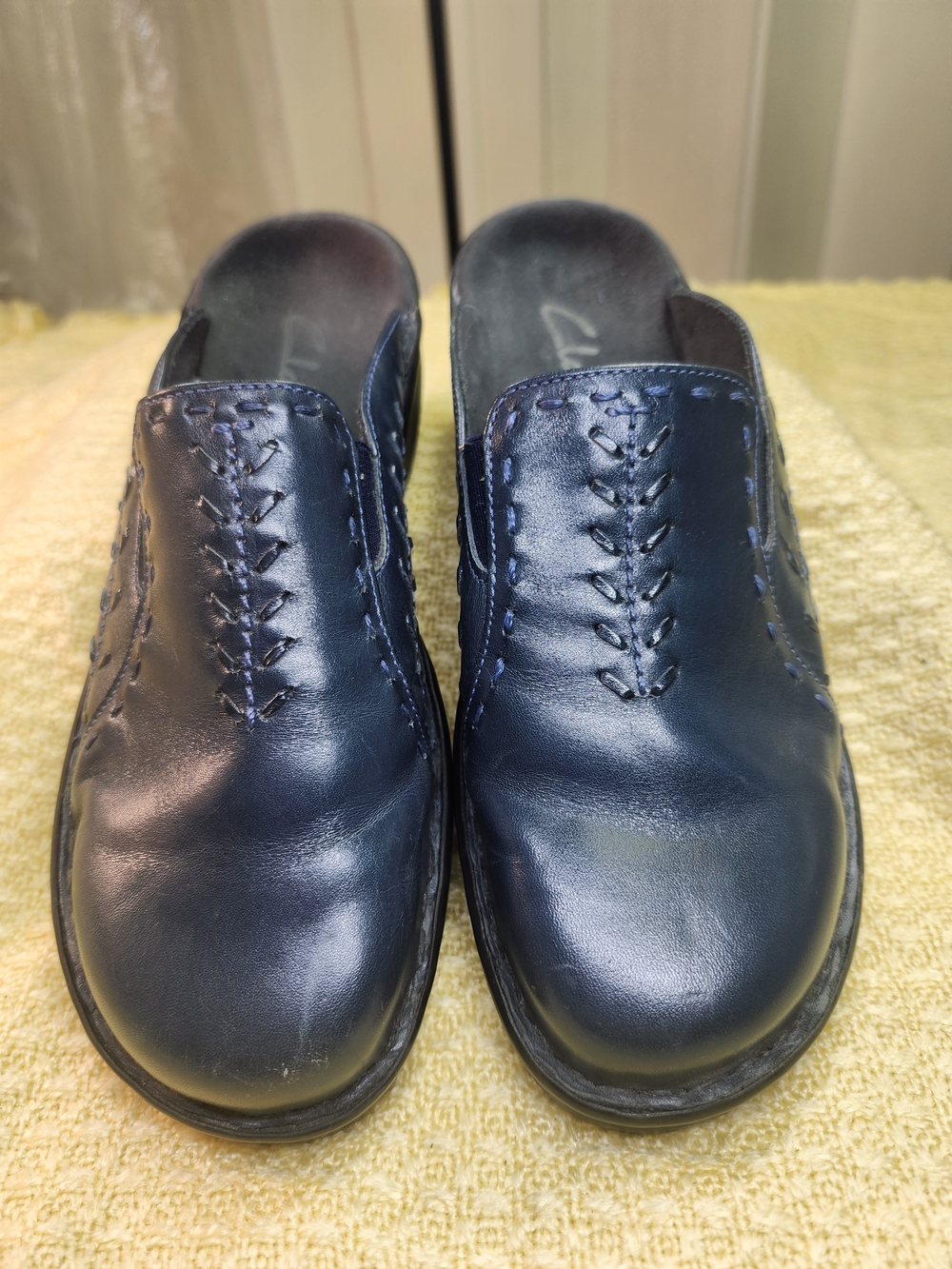 Clarks Women’s Navy Leather Slip-On Mules with Decorative Stitching